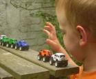 Niño jugando con coches de juguete