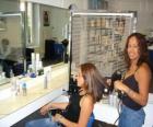 Peluquera peinando y secando el pelo a una clienta en el salón de belleza o peluquería