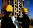 Técnico consultando un plano en la obra de construcción - Arquitecto, aparejador o ingeniero