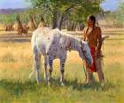 Guerrero indio junto a su caballo cerca del campamento