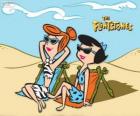 Vilma Picapiedra y Betty Mármol tomando el sol en la playa