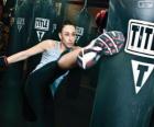 Luchadora de kickboxing o full contact entrenando los golpes con el saco