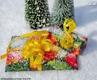 Dos regalos de Navidad sobre la nieve decorados con lazos amarillos
